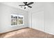 Bedroom with carpet, ceiling fan, window, and a closet at 4719 Sahalee Ln, Charlotte, NC 28216