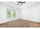 Bedroom with neutral carpet, ceiling fan, window, and vaulted ceiling at 4719 Sahalee Ln, Charlotte, NC 28216