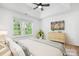 Bright bedroom with a large window, ceiling fan, and neutral decor at 4719 Sahalee Ln, Charlotte, NC 28216