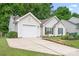 Charming single-story home with an attached garage, well-maintained lawn, and mature trees at 4719 Sahalee Ln, Charlotte, NC 28216