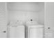 Laundry room with a washer, a dryer, and wire shelving for storage at 4719 Sahalee Ln, Charlotte, NC 28216