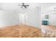 Spacious living room features wood floors, neutral paint, and an adjacent kitchen at 4719 Sahalee Ln, Charlotte, NC 28216