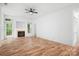 Bright living room with hardwood floors, modern ceiling fan, and a cozy fireplace at 4719 Sahalee Ln, Charlotte, NC 28216