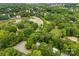 A landscape aerial showcases a pond and the surrounding lush greenery of the neighborhood at 4846 Deer Cross Trl, Charlotte, NC 28269