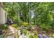 The landscaped backyard features flowering plants and mature trees, providing a private retreat at 4846 Deer Cross Trl, Charlotte, NC 28269