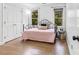 Simple bedroom with hardwood floors, neutral color palette and natural light from two windows at 4846 Deer Cross Trl, Charlotte, NC 28269