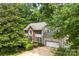 Beautiful two-story home with brick facade and attached garage, surrounded by lush greenery and mature trees at 4846 Deer Cross Trl, Charlotte, NC 28269