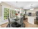 Eat-in kitchen featuring white cabinets, stainless appliances, granite countertops, and a large picture window at 4846 Deer Cross Trl, Charlotte, NC 28269