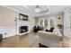 Bright living room with fireplace, hardwood floors, and french doors leading to the outside at 4846 Deer Cross Trl, Charlotte, NC 28269
