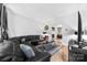 Modern living room with large black sectional sofa and a fireplace in the background at 4846 Deer Cross Trl, Charlotte, NC 28269