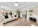 Open-concept living area connecting to the kitchen, featuring hardwood floors and a comfortable sofa with dark pillows at 4846 Deer Cross Trl, Charlotte, NC 28269