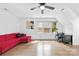 Large living space with red sofa, and desk area, and lots of light from the large window at 4846 Deer Cross Trl, Charlotte, NC 28269