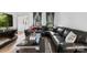 Contemporary living room featuring a black sectional sofa, modern decor and hardwood flooring at 4846 Deer Cross Trl, Charlotte, NC 28269