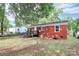 A large grassy backyard featuring a deck, with the house in the background at 4913 Winchester St, Charlotte, NC 28208