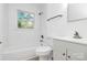 Updated bathroom features white subway tile surround and a bright window view at 4913 Winchester St, Charlotte, NC 28208