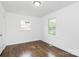 This bedroom features wood floors and a window with a view to the neighborhood at 4913 Winchester St, Charlotte, NC 28208