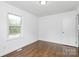 A light-filled bedroom featuring wood floors and a window offering ample natural light at 4913 Winchester St, Charlotte, NC 28208