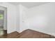 Clean, renovated bedroom with hardwood flooring and a white closet door at 4913 Winchester St, Charlotte, NC 28208