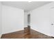 This bright bedroom features wood floors, white walls, and a door to the hallway at 4913 Winchester St, Charlotte, NC 28208