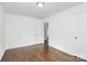 The bedroom has wood floors, white walls, and two access doors at 4913 Winchester St, Charlotte, NC 28208