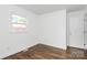 Bright bedroom boasts refinished hardwood floors and dual windows providing ample natural light at 4913 Winchester St, Charlotte, NC 28208