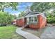 Quaint brick home with a well-manicured lawn and inviting walkway, offering a blend of classic charm and modern updates at 4913 Winchester St, Charlotte, NC 28208