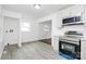 Modern kitchen featuring stainless steel appliances, white cabinets, and an open layout, connecting seamlessly to the adjacent living spaces at 4913 Winchester St, Charlotte, NC 28208