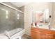 This bathroom offers a tiled walk-in shower with glass door, and is adjacent to a vanity with mirror at 511 W Finger St, Maiden, NC 28650