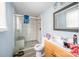 This bathroom offers a tiled walk-in shower with glass door and is adjacent to a vanity with a mirror at 511 W Finger St, Maiden, NC 28650