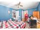 This bedroom features blue walls, wood-look flooring, and a ceiling fan at 511 W Finger St, Maiden, NC 28650