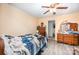 This cozy bedroom features yellow walls, wood-look flooring, and a ceiling fan at 511 W Finger St, Maiden, NC 28650