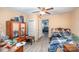 Bedroom with hardwood floors, tan walls, ceiling fan and is cluttered with personal items at 511 W Finger St, Maiden, NC 28650