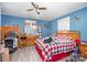 This cozy bedroom features warm blue walls, wood-look flooring, and a ceiling fan at 511 W Finger St, Maiden, NC 28650