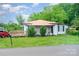 Charming single-story home with a metal roof and a inviting wooden deck at 511 W Finger St, Maiden, NC 28650