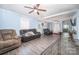 Spacious living room featuring a ceiling fan and vinyl floors at 511 W Finger St, Maiden, NC 28650