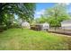 Lush backyard showcasing green lawn, mature trees, and convenient access ramp to additional building at 512 Forest Ln, Rock Hill, SC 29730