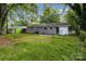 An ample yard and green lawn provide a relaxing backdrop at 5715 Coulee Pl, Charlotte, NC 28217