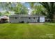 Large, grassy backyard offers ample space for outdoor activities at 5715 Coulee Pl, Charlotte, NC 28217