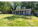 Charming single-story home with covered porch and a partially overgrown lawn at 5715 Coulee Pl, Charlotte, NC 28217