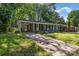 Traditional home exterior with a covered porch and single carport at 5715 Coulee Pl, Charlotte, NC 28217