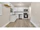 Well-lit kitchen featuring new appliances, stylish cabinets, and granite counters at 5715 Coulee Pl, Charlotte, NC 28217