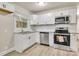 Modern kitchen with white cabinets, stainless steel appliances, and granite countertops at 5715 Coulee Pl, Charlotte, NC 28217