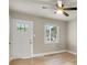 Cozy room with a ceiling fan, a white door with glass panes, and natural light at 5715 Coulee Pl, Charlotte, NC 28217