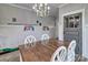 Cozy dining room featuring a rustic table, wainscoting, and a charming chandelier at 6650 Highway 341 Hwy, Kershaw, SC 29067