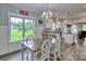 Dining area featuring a modern chandelier, ample natural light, and backyard views at 6650 Highway 341 Hwy, Kershaw, SC 29067