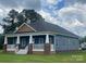 Charming blue home with a covered front porch, white columns, and manicured lawn at 6650 Highway 341 Hwy, Kershaw, SC 29067