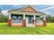 Charming blue home with a welcoming porch and a well-manicured lawn at 6650 Highway 341 Hwy, Kershaw, SC 29067