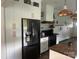 Modern kitchen with stainless steel appliances, white cabinetry, and butcher block countertop at 6650 Highway 341 Hwy, Kershaw, SC 29067