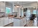 Bright open kitchen featuring a butcher block island, stainless steel appliances, and white cabinets at 6650 Highway 341 Hwy, Kershaw, SC 29067