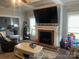 Inviting living room featuring a fireplace, mantle with TV, and neutral color palette at 6650 Highway 341 Hwy, Kershaw, SC 29067